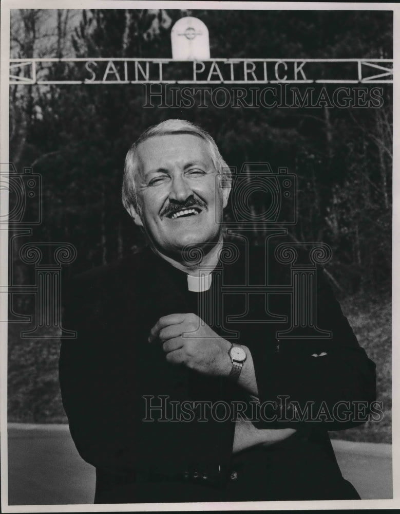 1987, Father Patrick Sullivan in front of Church in Adamsville - Historic Images