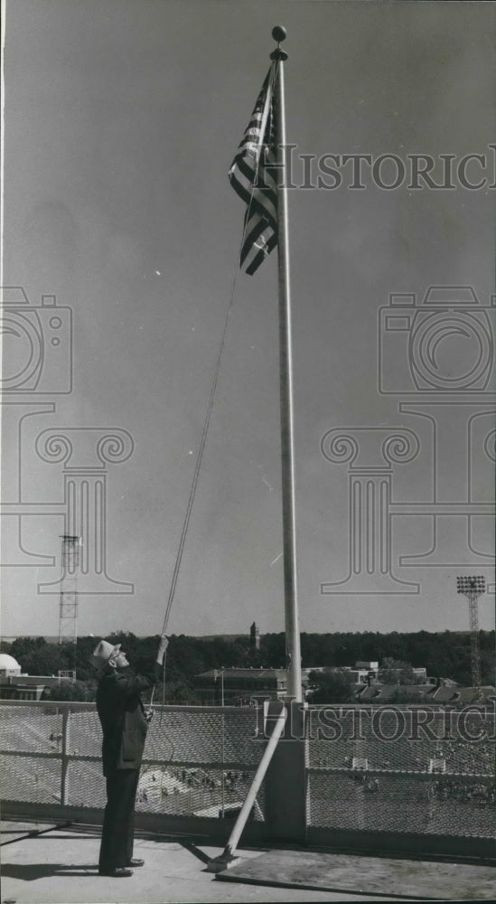 1981 William P. "Pop" Thaxon raises flag in Denny Stadium - Historic Images