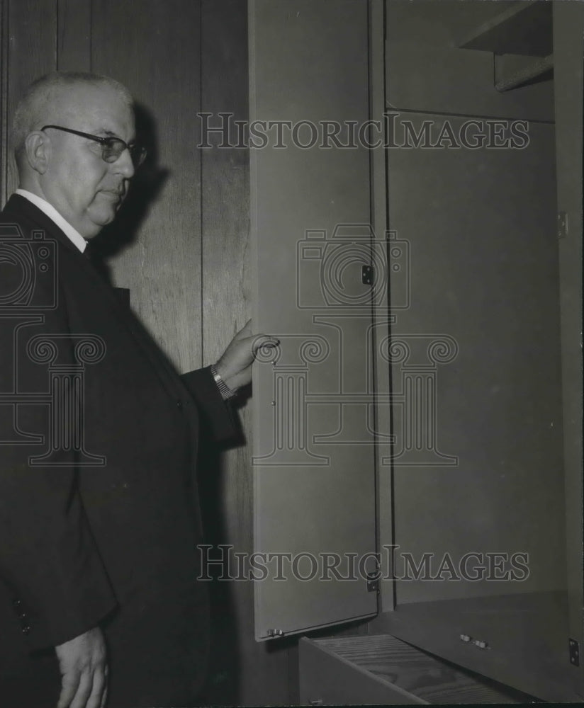 1966, Boys Ranch Superintendent John L. Tarrant inspects ranch closet - Historic Images