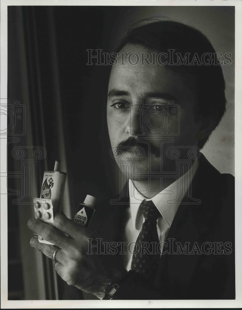 1986, Altheia House director Chris Retan holds items used to get high - Historic Images