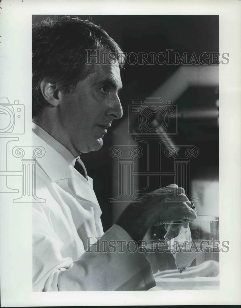 1988, Doctor William Torres with Kidney stone test sample - abna39382 - Historic Images