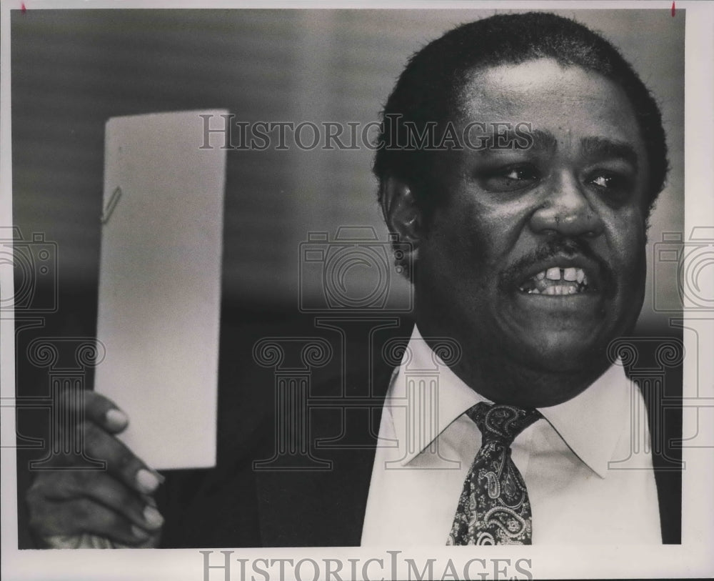 1989 Representative John Rodgers, Democrat, Birmingham holds a bill - Historic Images