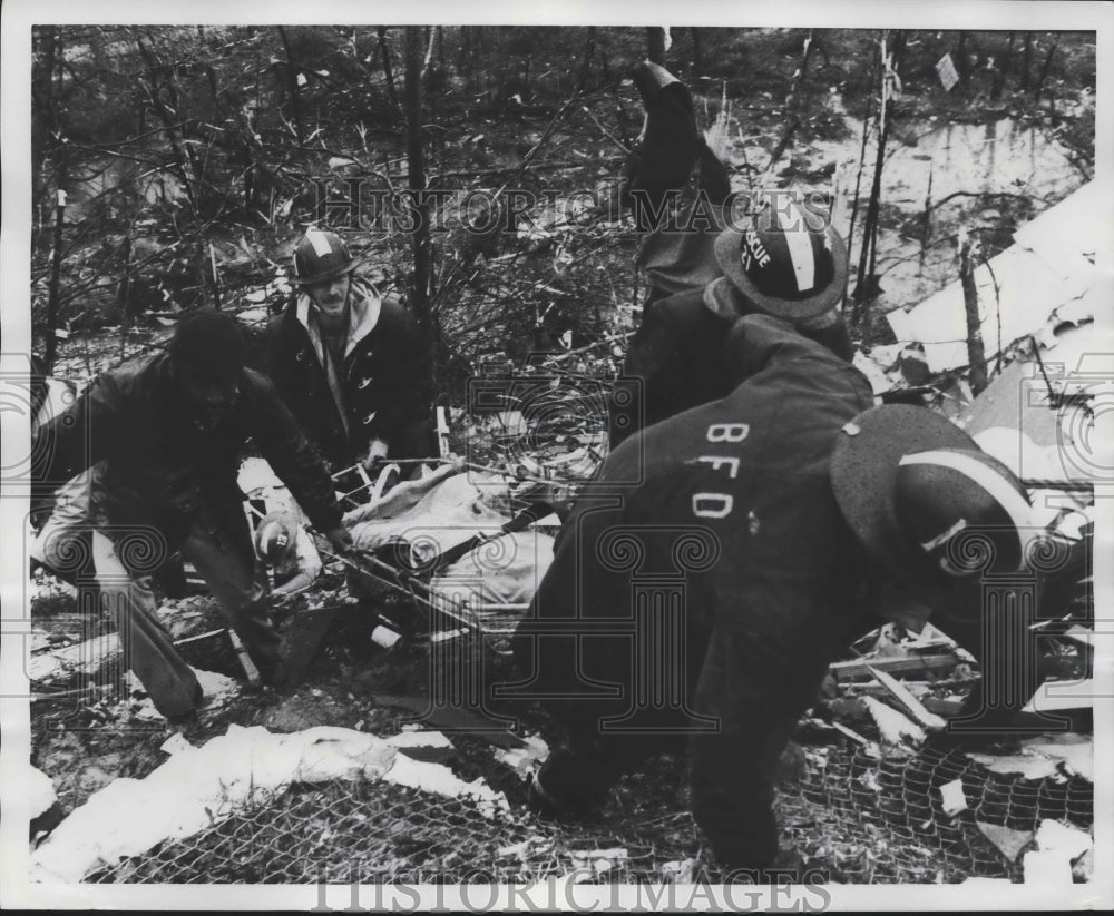 1977, fire department rescuing person from tornado debris, Alabama - Historic Images