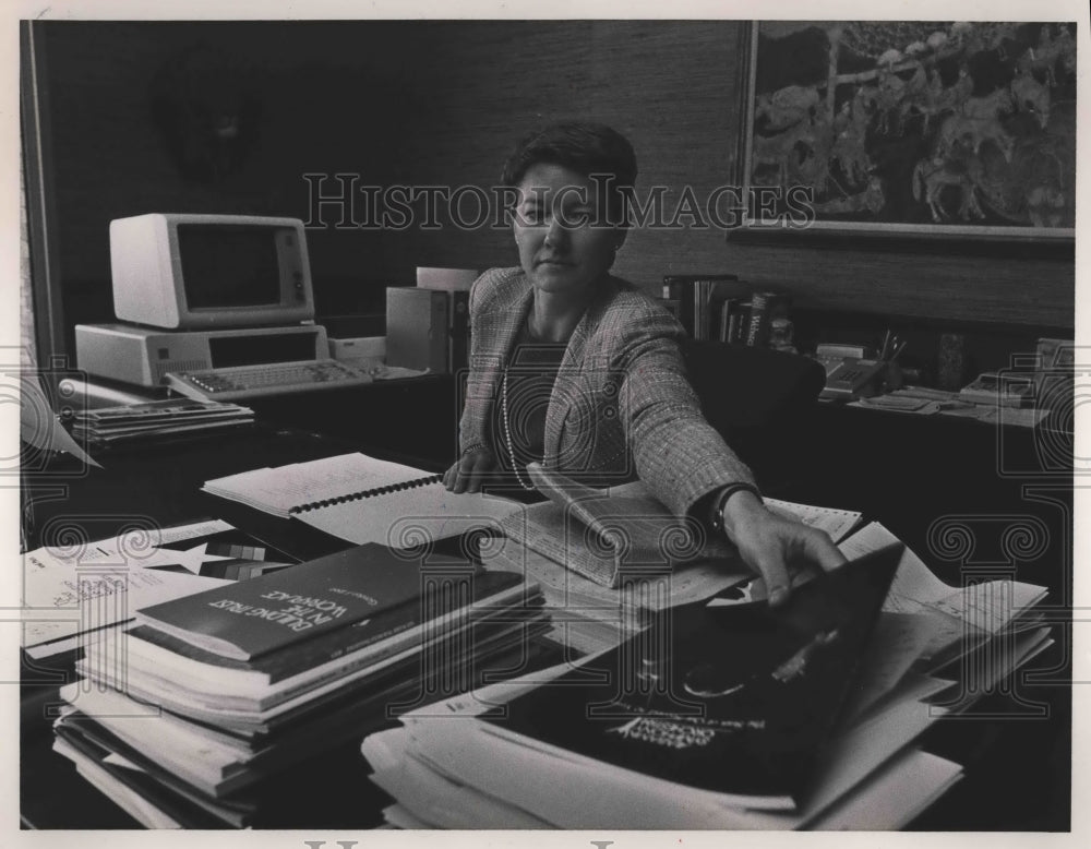 1985, Judith Thompson working behind desk, Thompson Tractor, Alabama - Historic Images