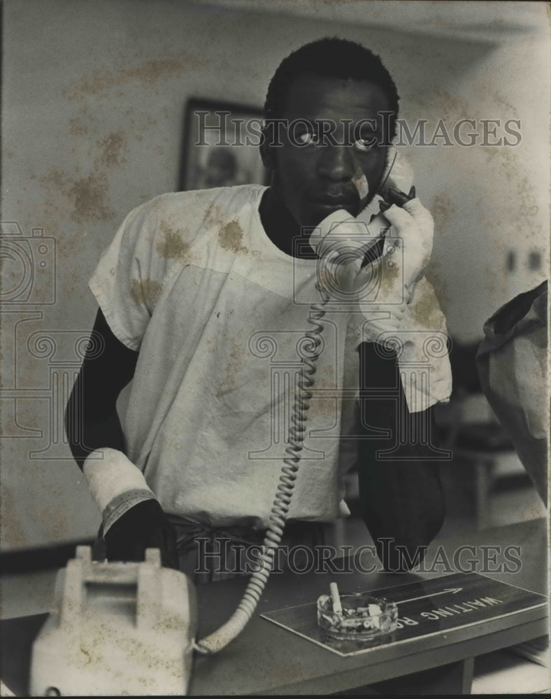 1977 Bandaged Horace Berry on phone in Jefferson County - Historic Images