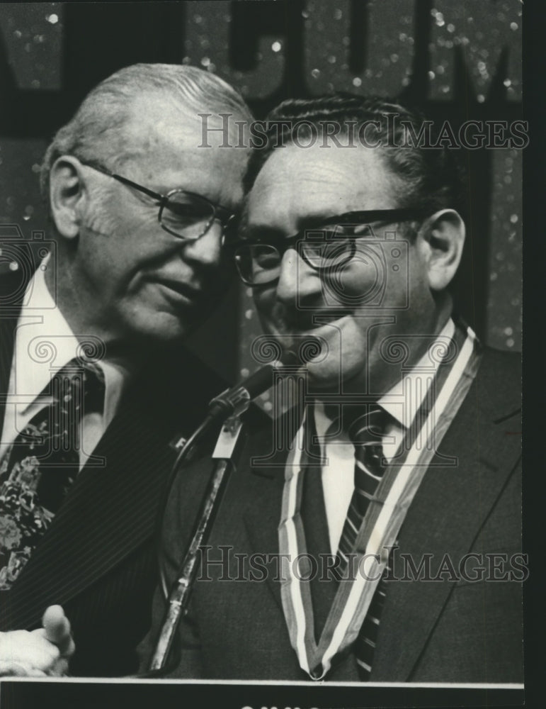 1975, Henry Kissinger with J. D. Hayes at microphone in Birmingham - Historic Images