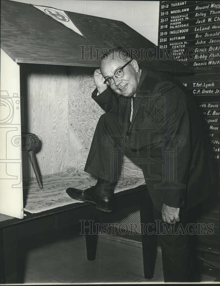 1965, M. E. Hensley of United Appeal steps into dog house - abna40361 - Historic Images