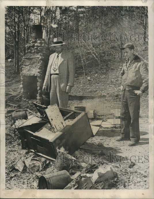 1952, Sheriff A. A. Pate of Calhoun County examines oil stove - Historic Images