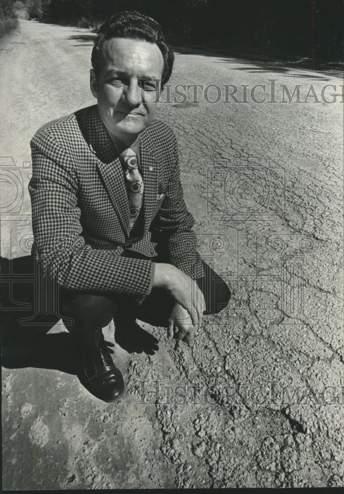 1977, Grady Perry next to road needing repairs, Walker County - Historic Images