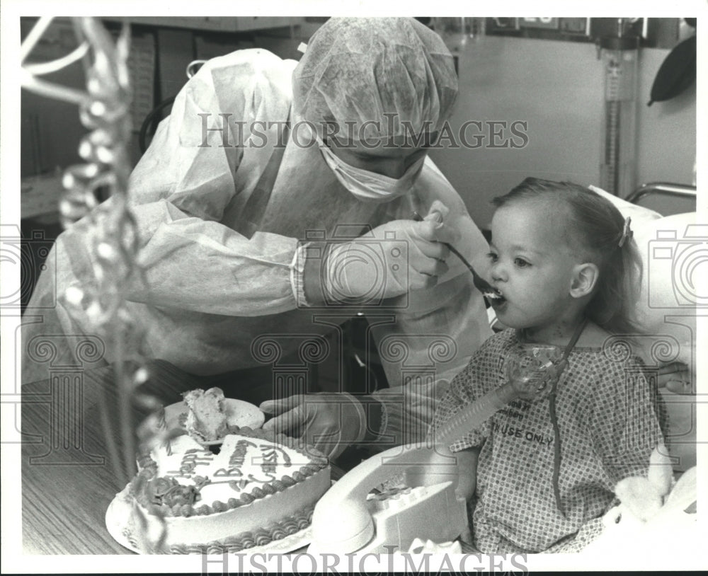1986, Heart Transplant Patient Christina Hethcox eats birthday cake - Historic Images