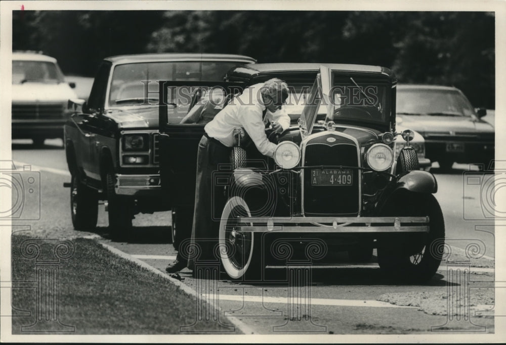1989 Merritt Pizitz of Birmingham Works on his Model A Ford in road - Historic Images