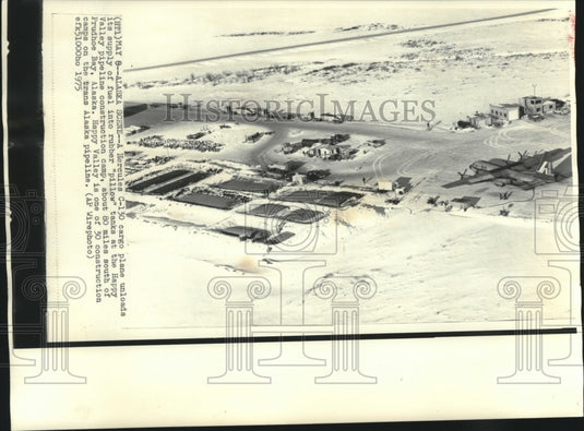 1975, Cargo Plane unloads fuel into tanks at Happy Valley Camp - Historic Images