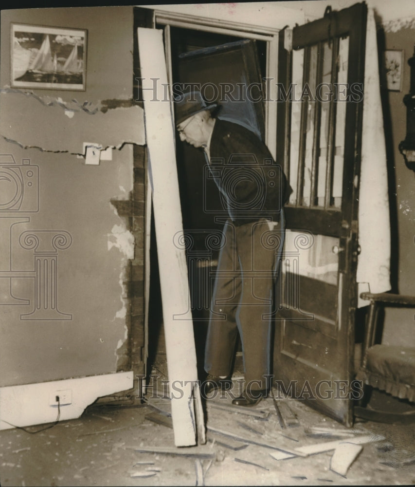 1955, T. F. Caldwell examines explosion at his home - abna42493 - Historic Images