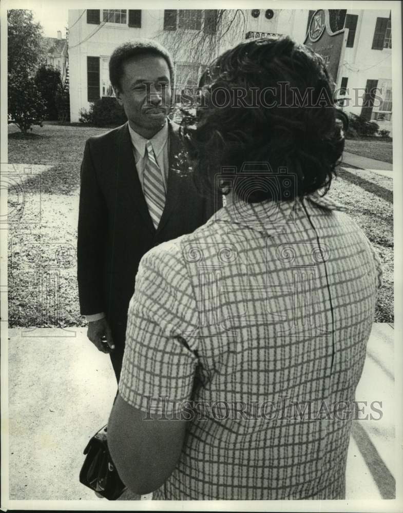 1970 Rev. William McKinley Branch shaking hand with woman, outside - Historic Images