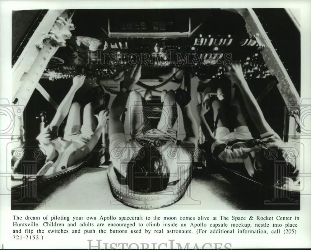 Press Photo Visitors inside Apollo capsule mockup at Space &amp; Rocket Center, AL - Historic Images
