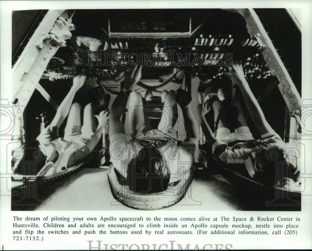 Press Photo Visitors inside Apollo capsule mockup at Space & Rocket Center, AL - Historic Images