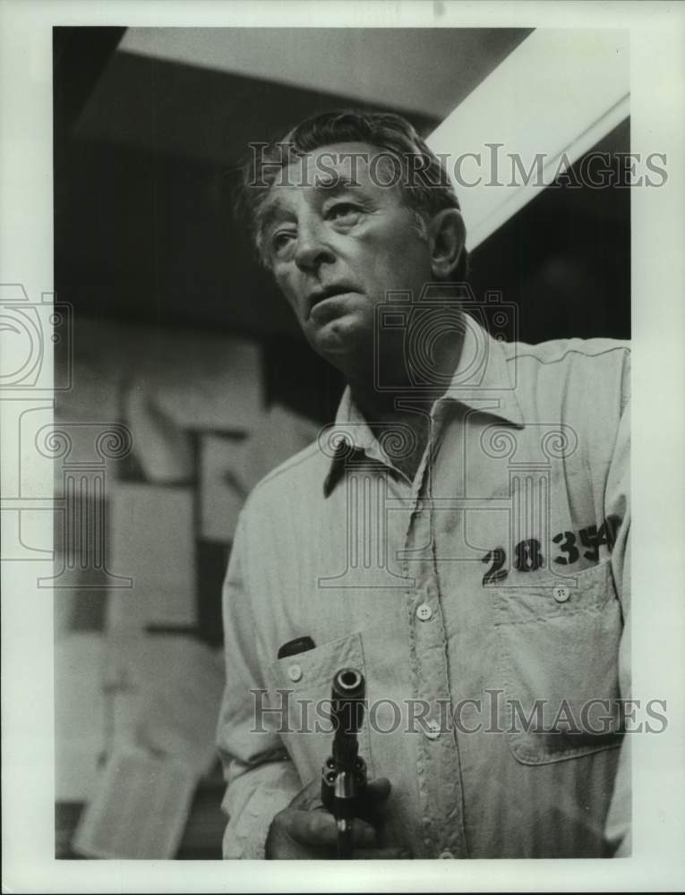Press Photo Actor Robert Mitchum in character, holding gun - abna43912 - Historic Images