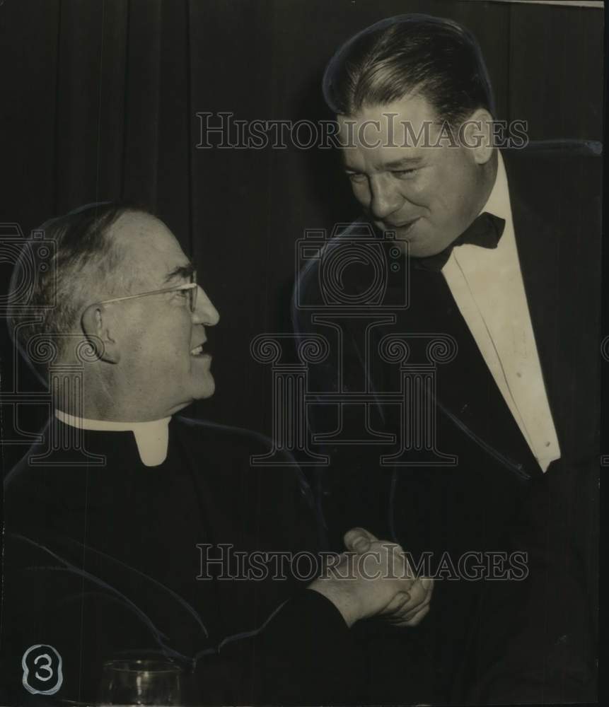 Press Photo Man in Clergyman&#39;s Uniform Shakes Hands with Man in Formal Clothes - Historic Images