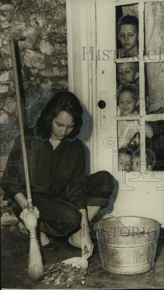 1955, Martha Joy Brown sweeps at dynamited home during strikes - Historic Images