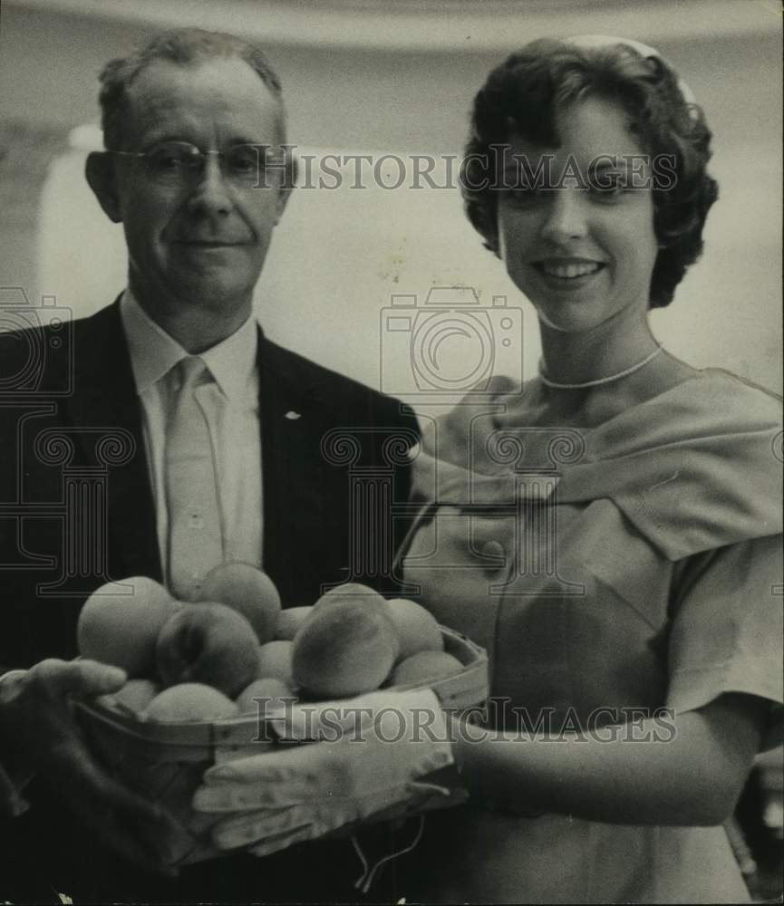 1961, AL. Gov. Albert Boutwell gets peaches from Mary Cate Tucker, AL - Historic Images