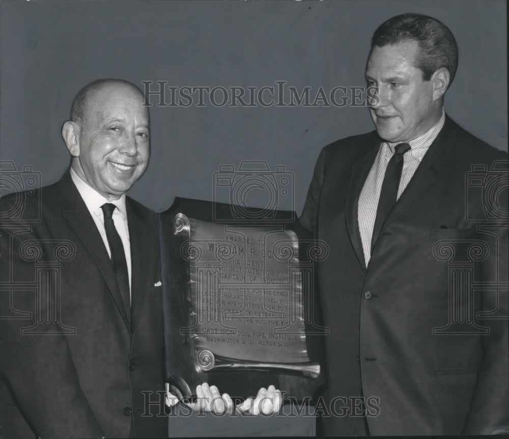 1966, William Bond holds plaque from Cast Iron Institute in Dallas - Historic Images