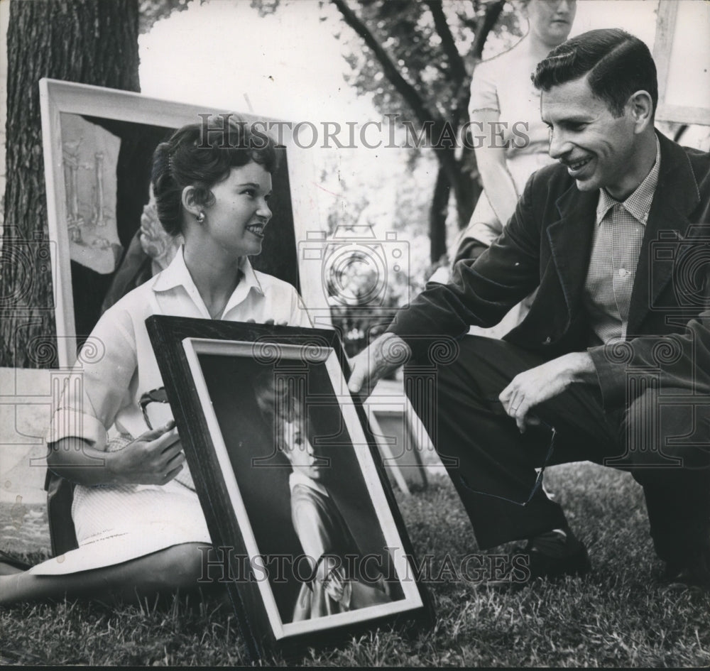 1960, Mrs. Kay Arrowood shows painting to man at Birmingham Art Show - Historic Images