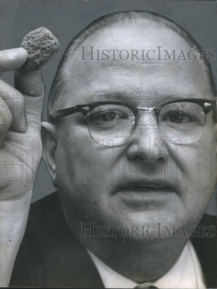 1968, Doctor Woodrow R. Byrum with pellet from Bible days, Alabama - Historic Images