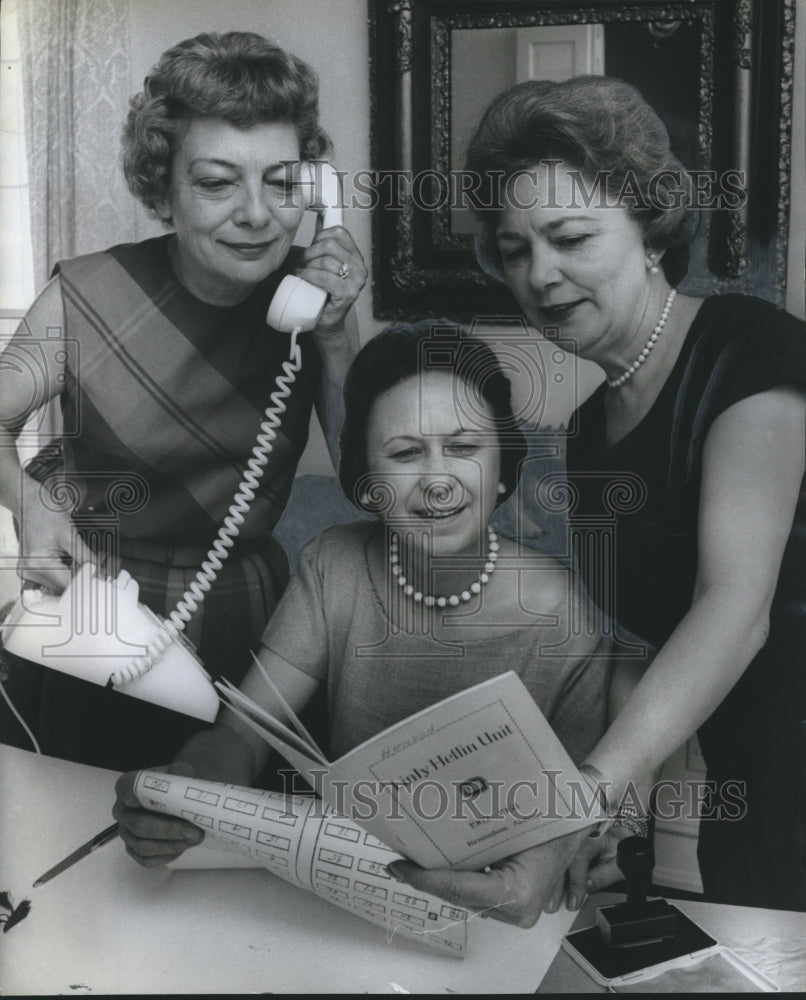 1963, Three women plan Linly Heflin Fashion Show during Luncheon - Historic Images