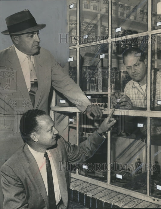 1960, Police show filling station operator how to apply tape - Historic Images