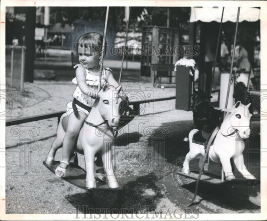 1960, Child on merry-go-round at Kiddieland in Birmingham, Alabama - Historic Images