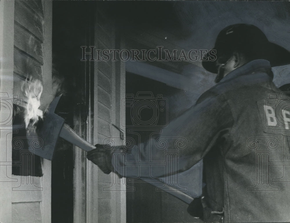 1966, Fireman uses ax to get to Fire in Birmingham, Alabama Building - Historic Images