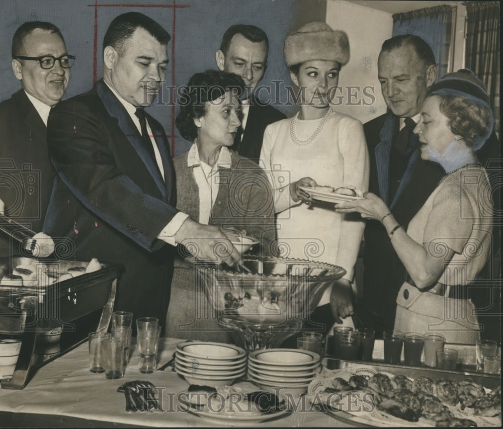 1965, Group gathers to discuss Festival of Arts over a meal - Historic Images