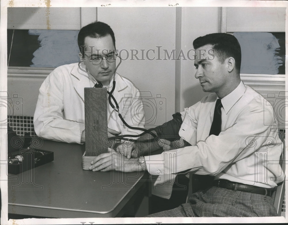 1953, Birmingham Veterans Hospital doctor examines patient - Historic Images