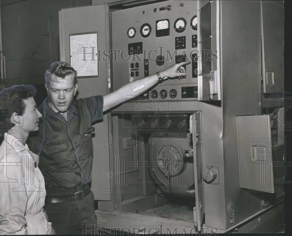 1958 Press Photo Austin Blevins points to electrical panel, University Hospital - Historic Images