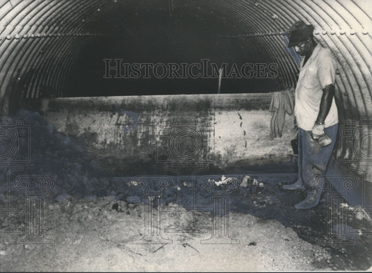 1977, Unidentified workman inspects "dam" near Belwood area, Alabama - Historic Images