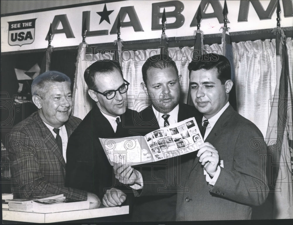 1965 Press Photo Travel leaders looking at booklet of things to do in Alabama - Historic Images