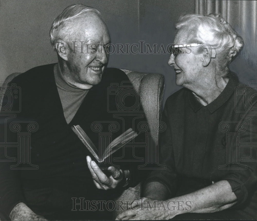 1969, Mr. and Mrs. William Thornton Estes with book, portrait - Historic Images