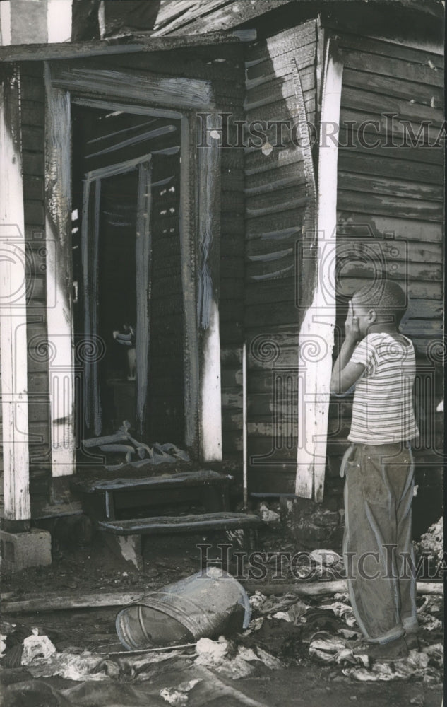 1951, Child looks at fire damaged home in Birmingham, Alabama - Historic Images