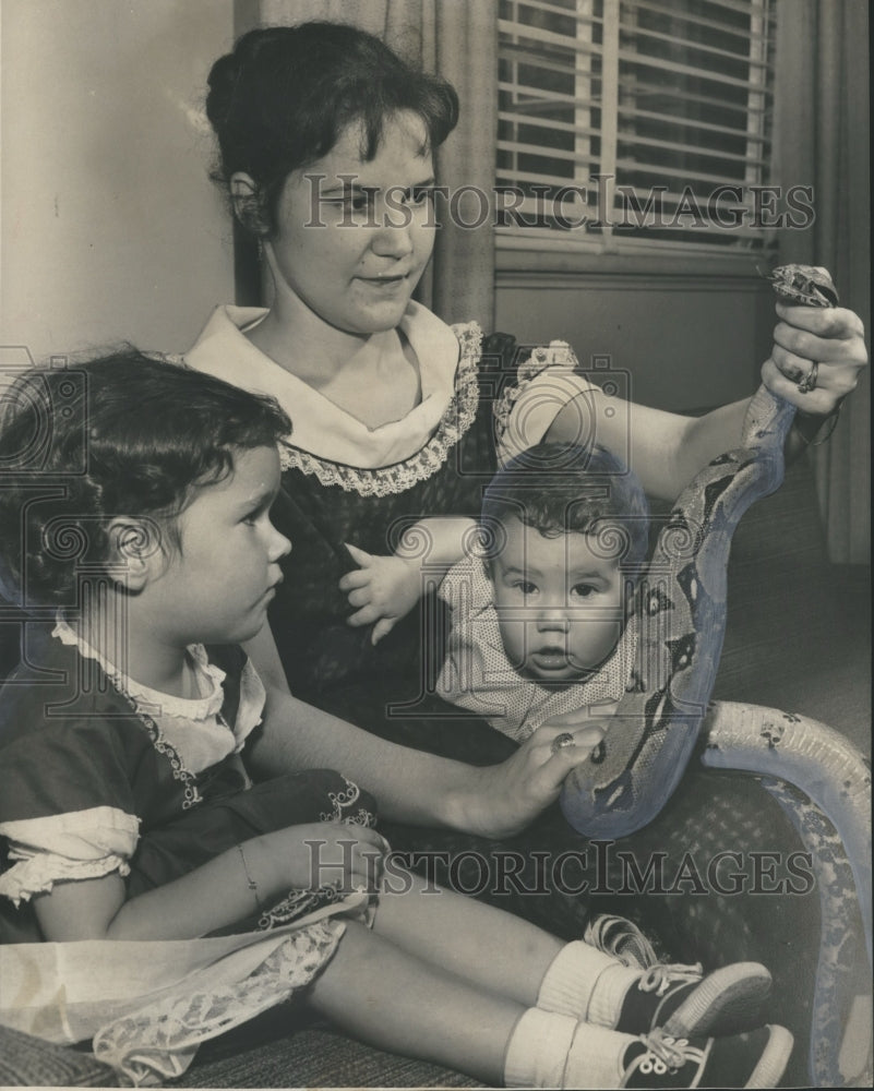 1960, Liszia Truett holds constrictor with Marietta and Bob - Historic Images