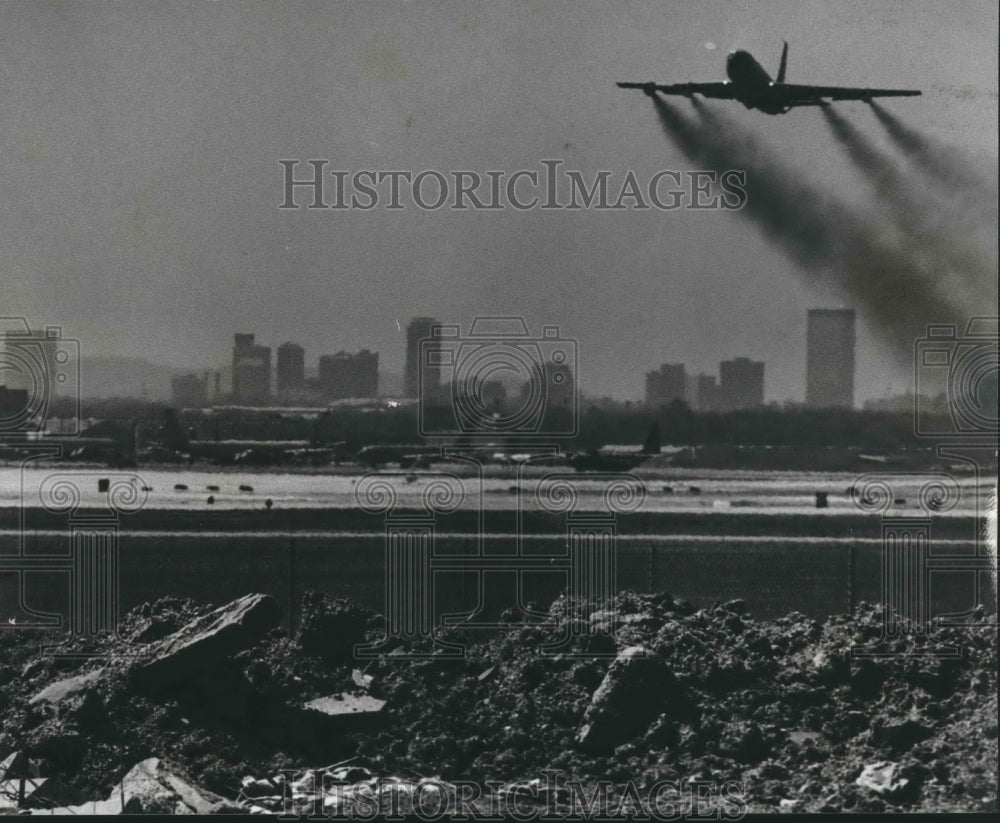 1979 Plane flies over land once part of someone&#39;s yard, Birmingham - Historic Images