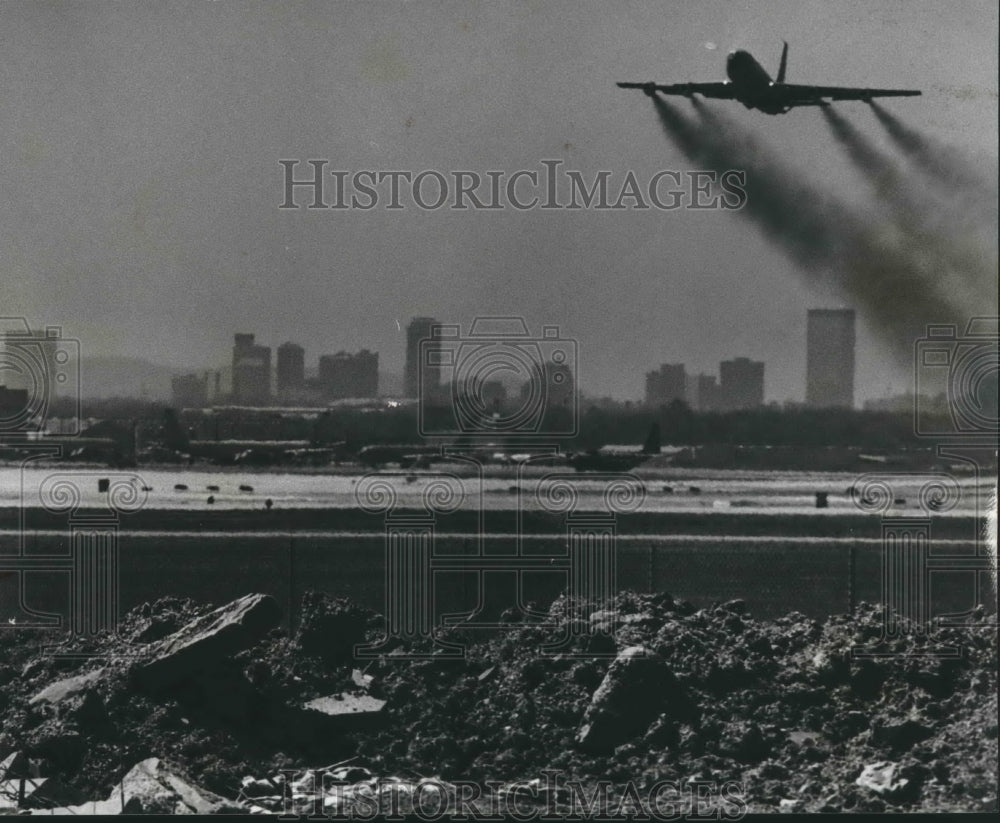 1979 Plane flies over land once part of someone's yard, Birmingham - Historic Images