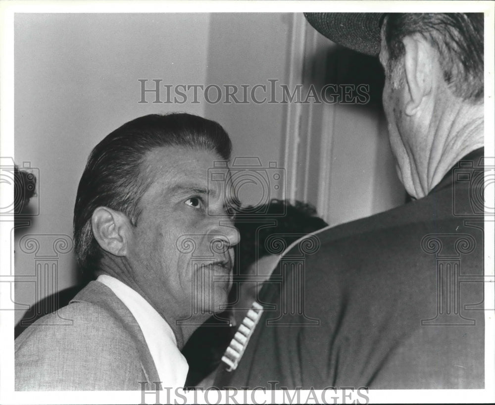 1979, Attorney Sheffield talks to police officer - abno04463 - Historic Images