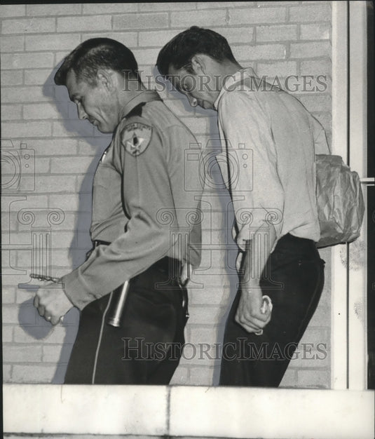 1966, Wilton O'Neal Trott led from hearing by Deputy Norris Champion - Historic Images