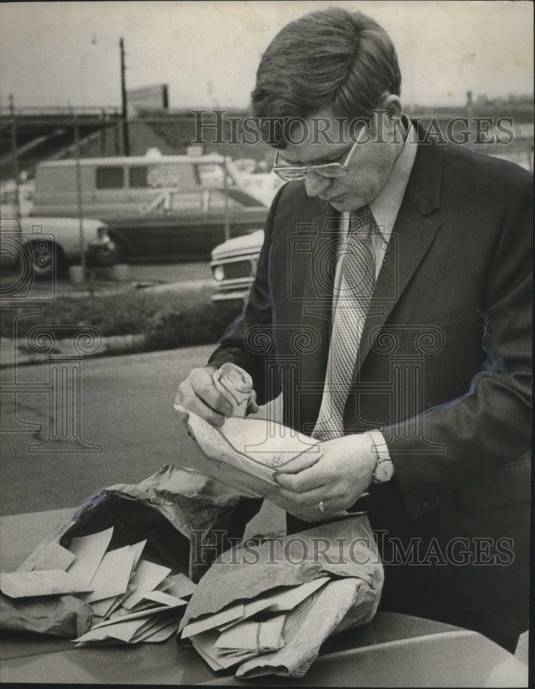 1971, Sergeant Pate, checks confiscated lottery slips, Birmingham, AL - Historic Images