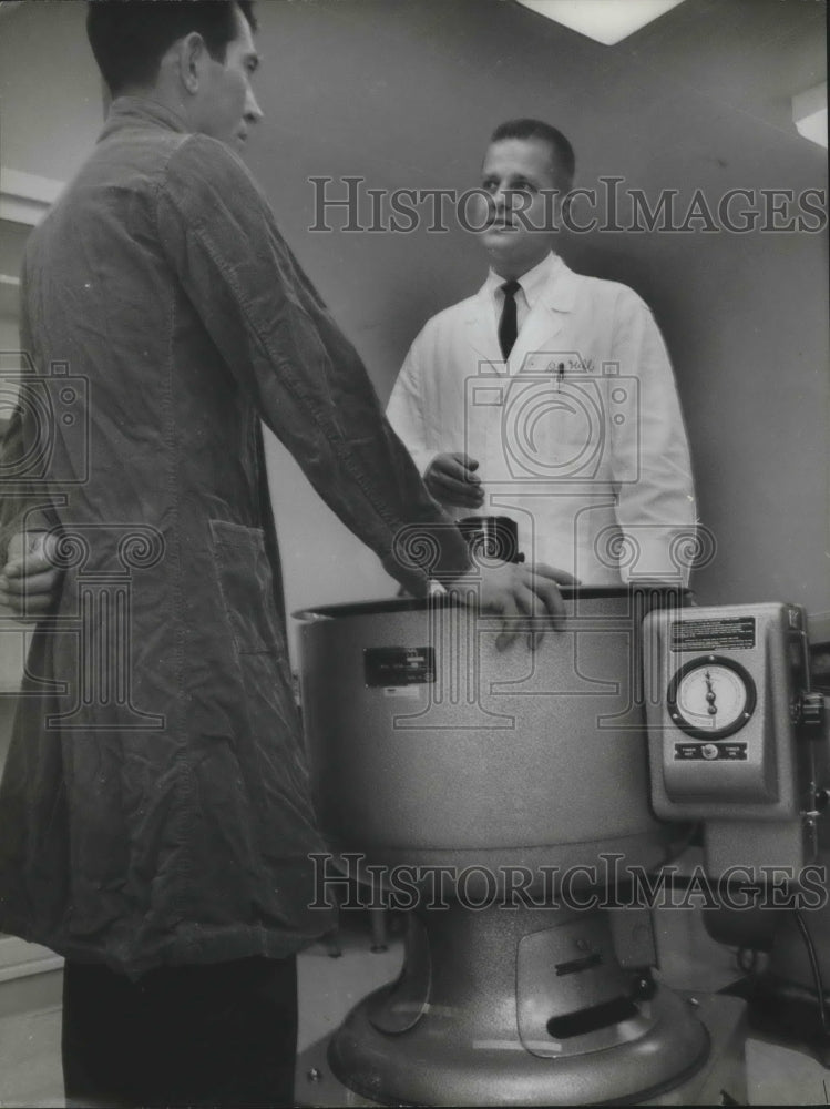 1962, Doctor S. Richardson Hill Jr., with centrifuge and patient - Historic Images