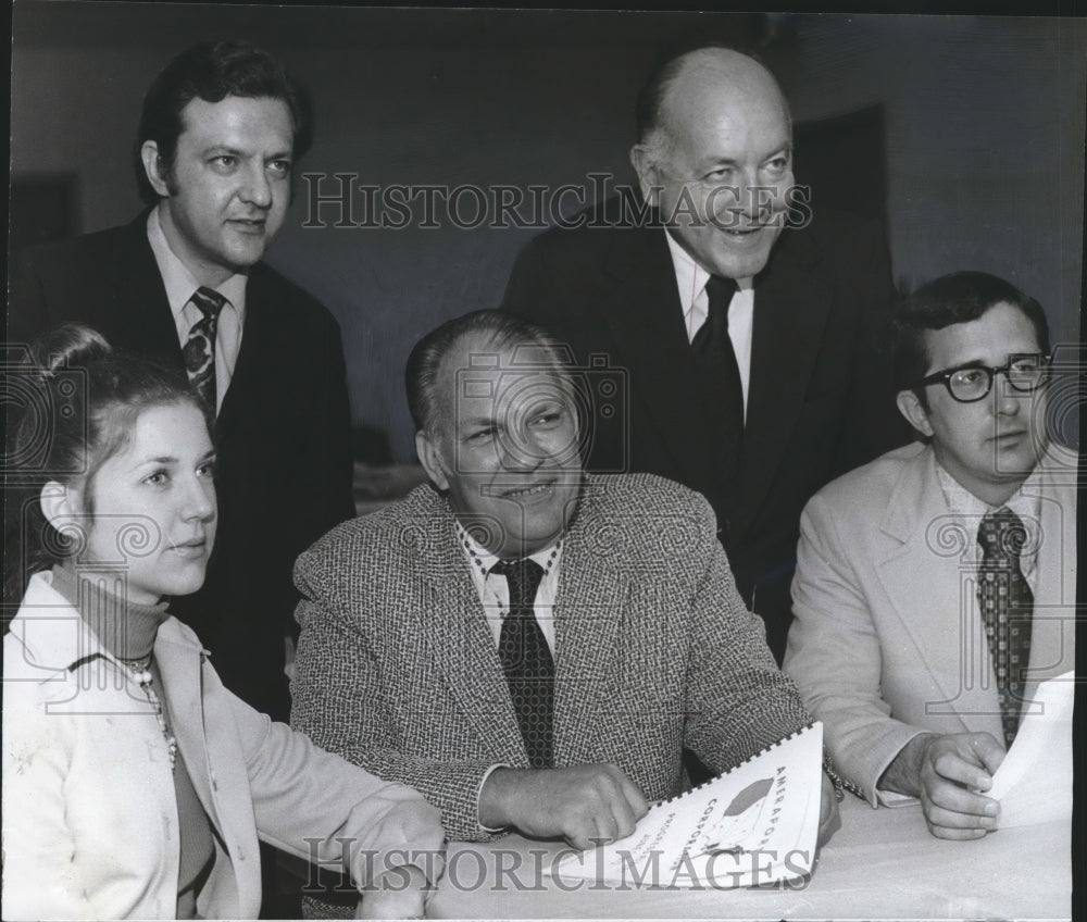 1973, Dr. John Moeller and other officials review Ameraport report - Historic Images