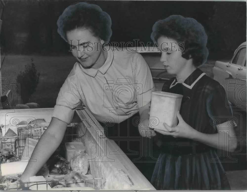 1963 Press Photo Mrs. Bill Nugent and daughter Paula, getting food from freezer - Historic Images