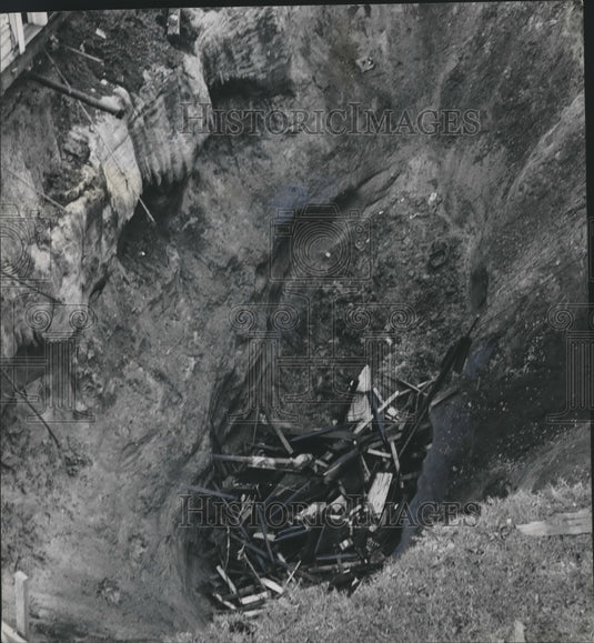 1964, Giant crater growing, 40 feet deep, Sink Holes in Birmingham - Historic Images
