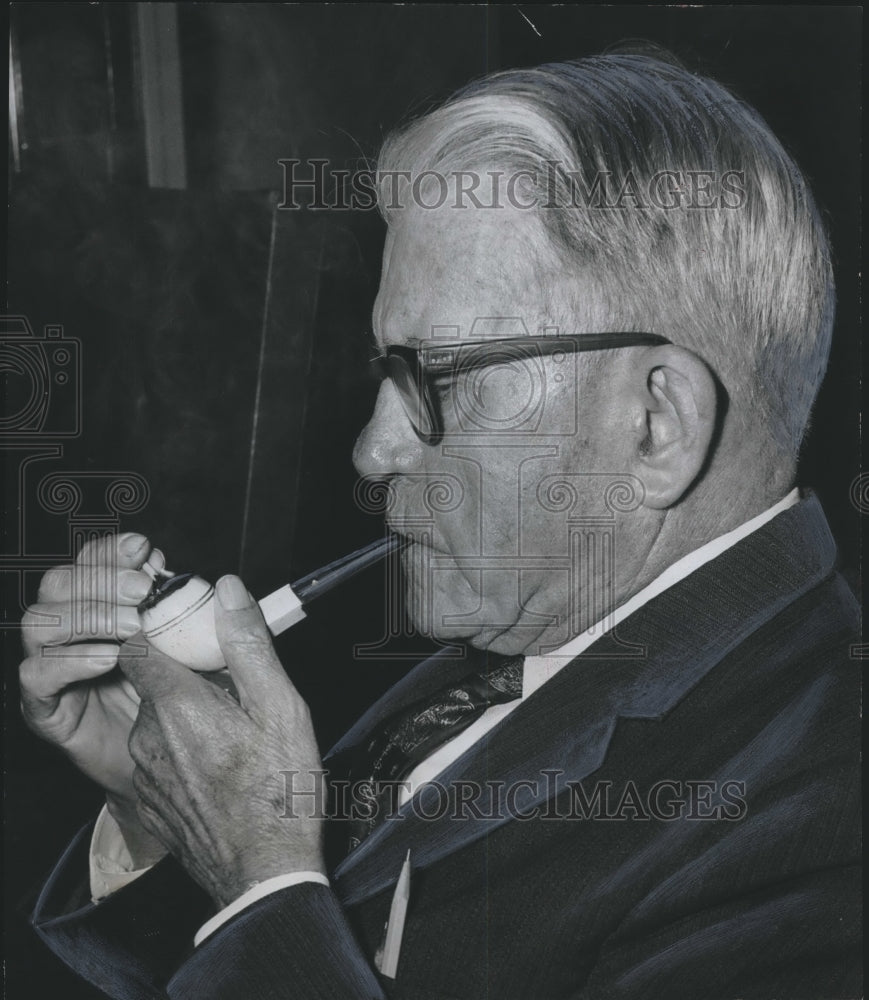 1961, County Commissioner Charles Harrison smokes pipe - abno06835 - Historic Images