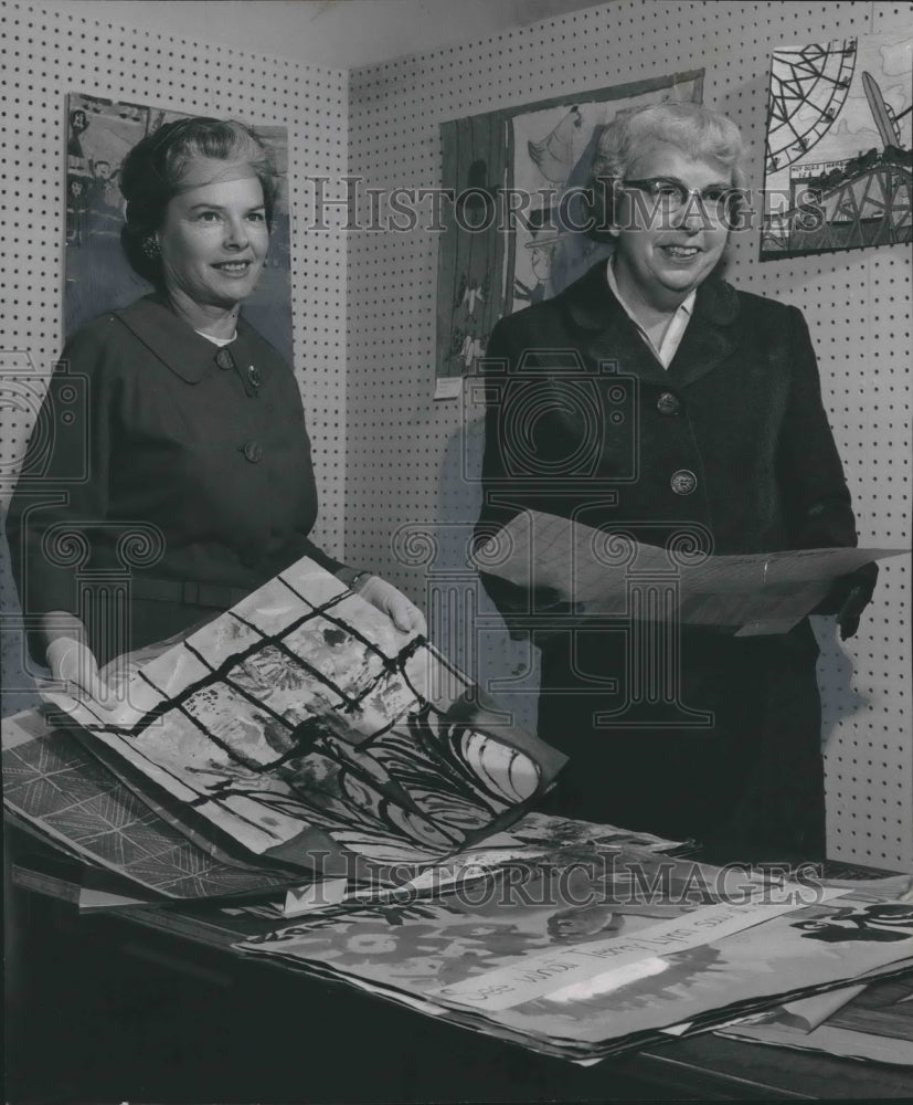 1961, Mrs. C. W. Kelly with Vera Wilson go through Student Paintings - Historic Images